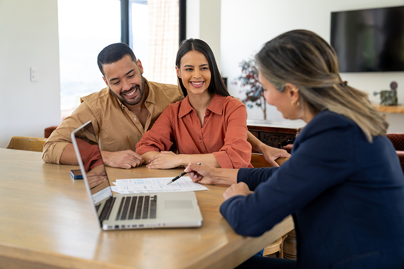 Financial advisor talking to a couple about buying a house